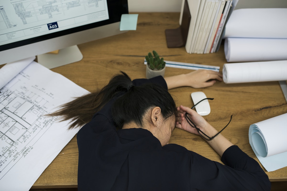 Four Mistakes Moms Make At Work woman asleep at work desk