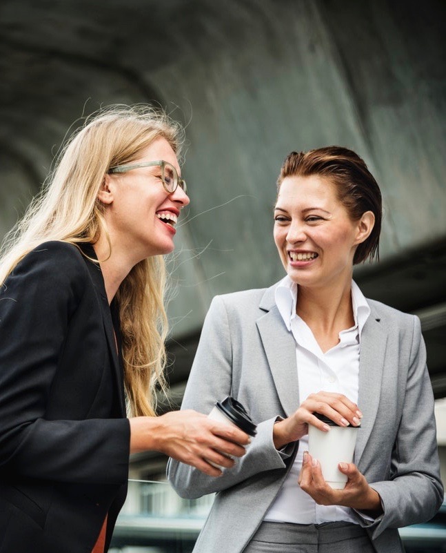 two women talk outside of work
