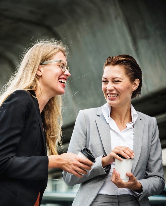 Four Mistakes Moms Make At Work two women talk outside of work