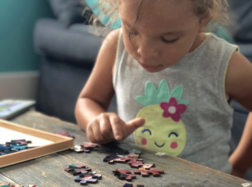 girl doing puzzle