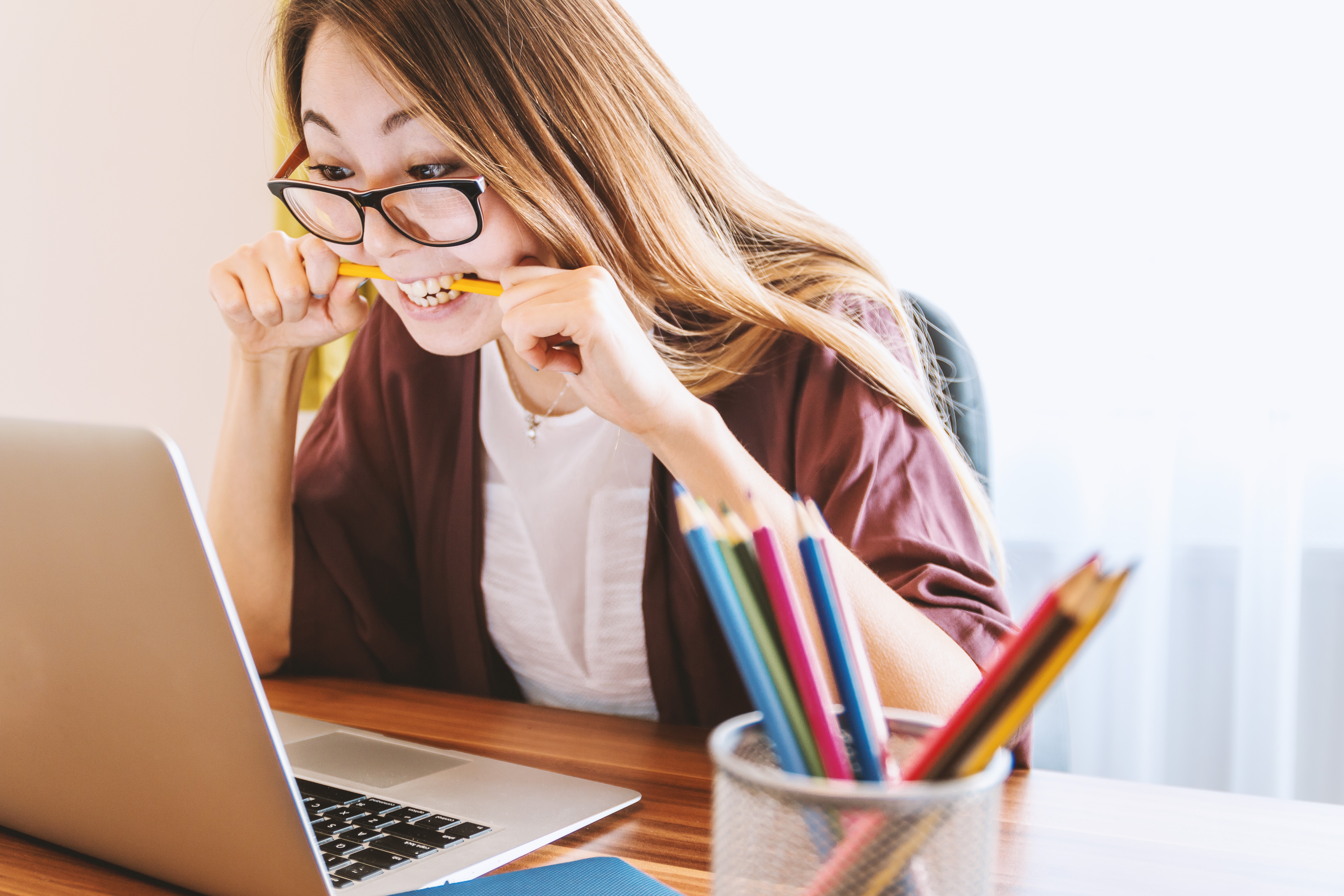 How to change your mindset about money woman biting pencil