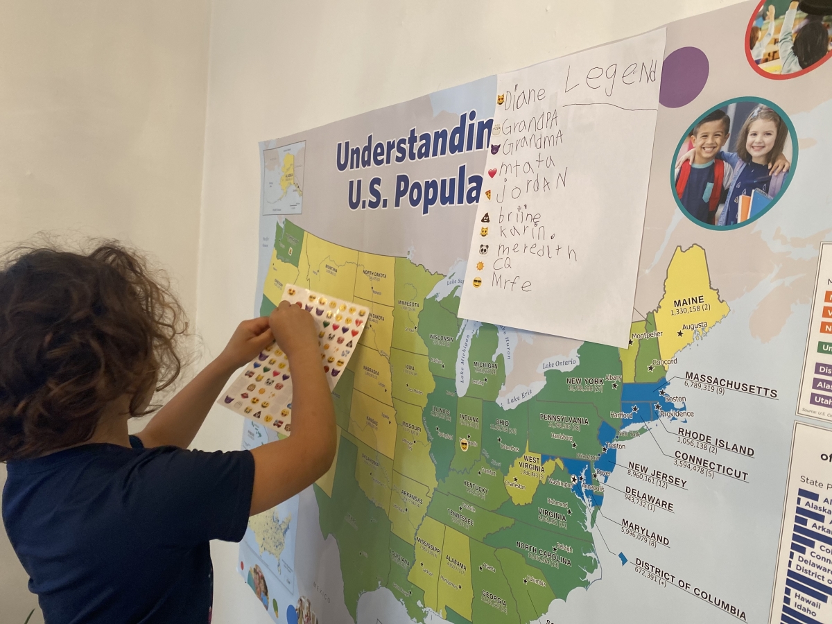 child working with US map